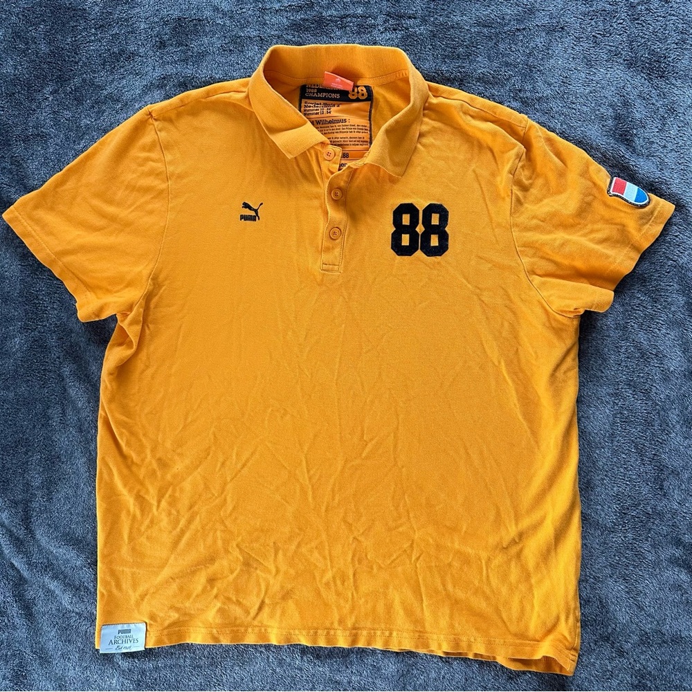 Puma Men's Mustard Polo Shirt with Black Accents Nederlands Soccer Team